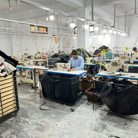 AJSAMCO motorcycle apparel manufacturing factory floor in Sialkot Pakistan